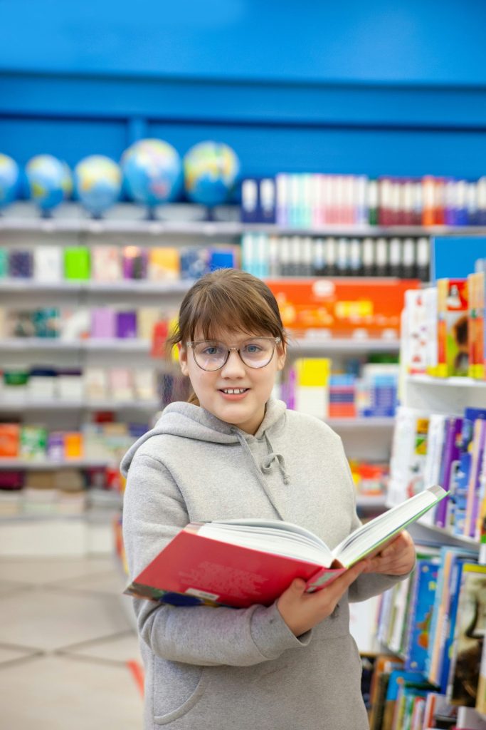 a person holding a book in a library