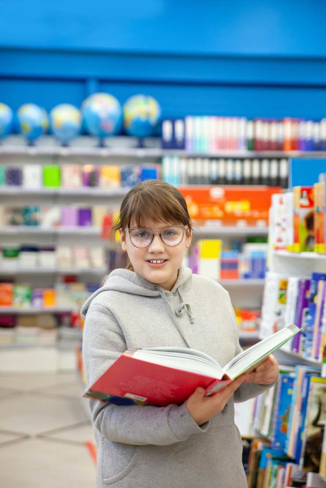 a person holding a book in a library